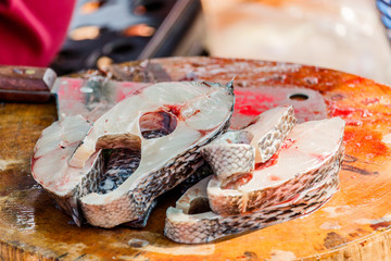 Fish slices on cutting board in local market. Thailand
