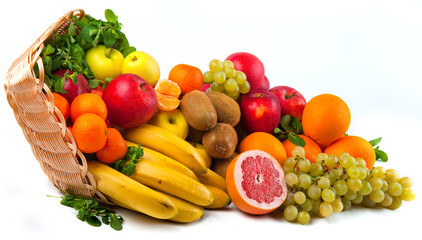 Composition with vegetables and fruits in wicker basket isolated