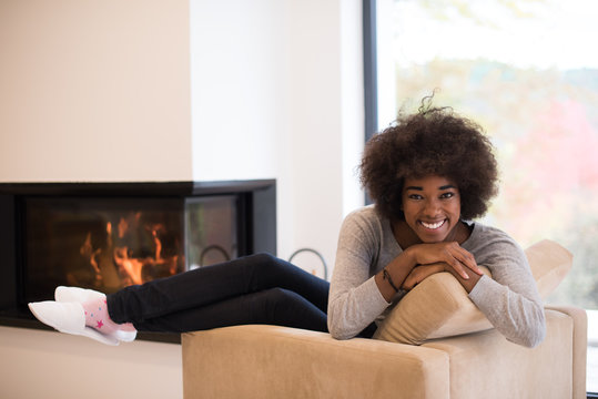 black woman in front of fireplace