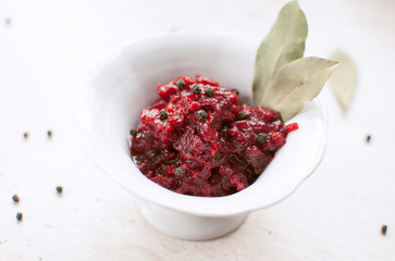 Homemade tomato sauce with bay leaf in the white bowl