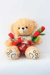 Brown teddy bears and red roses on a white background.