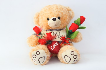 Brown teddy bears and red roses on a white background.