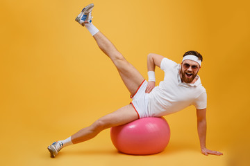 Happy Sportsman Engaged in aerobics on fitness ball