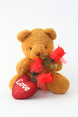 Brown teddy bears and red roses on a white background.