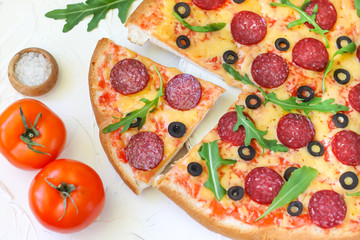 Pizza with sausage and rucola 