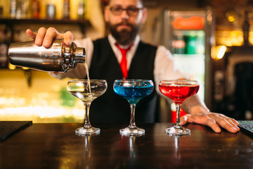 Bartender making alcohol beverages in nightclub