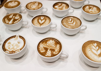 Cups of coffee with heart latte art on top