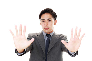 禁止の意思表示をするビジネスマン