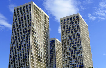 Fototapeta na wymiar Brick and mortar buildings and skyscrapers with blue sky background