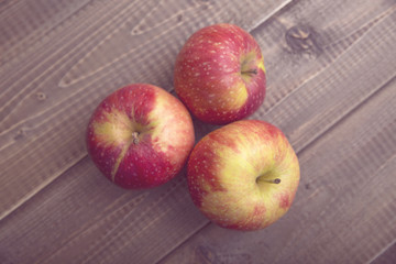 Red apples on a wooden table