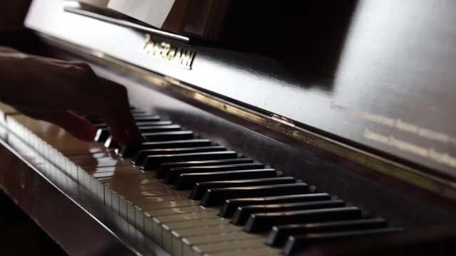 Hands playing the piano
