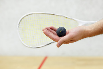 squash player serving a ball