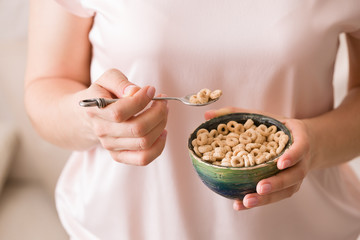 Closeup of woman's hands holding bowl with organic whole wheat cereal. Healthy Breakfast or snack. Healthy food and eating.