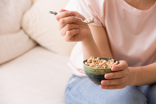 Closeup of woman's hands holding bowl with organic whole wheat cereal. Healthy Breakfast or snack. Healthy food and eating.