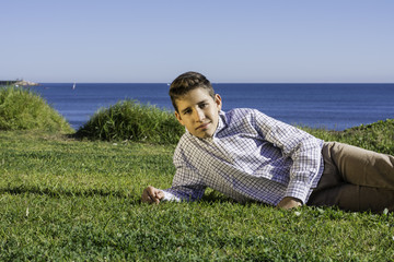 Fototapeta na wymiar handsome boy lying on grass