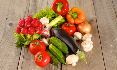 Composition with assorted raw organic vegetables wooden table
