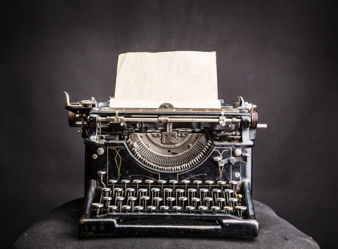 Old black typewriter with paper