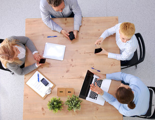 Image of business partners discussing documents and ideas at meeting