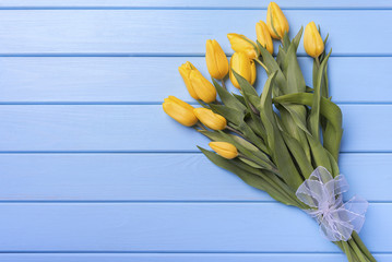 Yellow tulips on blue boards.
