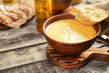 Delicious cream soup with bread on table