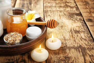 Tray with beautiful honey spa composition on wooden table