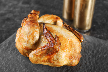 Grilled beer can chicken on slate plate
