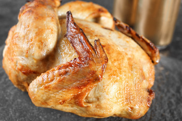 Grilled beer can chicken on slate plate