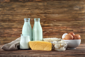 Different dairy products on wooden background