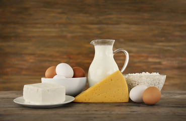 Different dairy products on wooden background