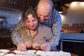 An elderly couple counting money and a budget.