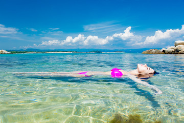 beautiful young woman swimming in the wonderful clean sea in greece