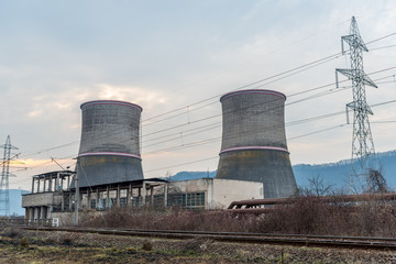 Obraz premium Cooling towers of thermal power plant near the railway