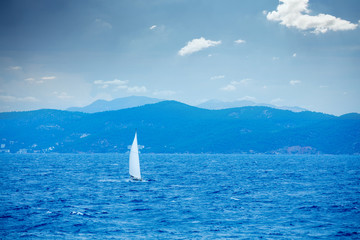 Naklejka premium photo of beautiful ship in the sea on the wonderful mountains background in Greece
