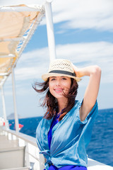 photo of beautiful young woman on the boat in front of sea background in Greece