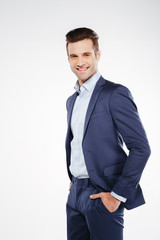 Vertical image of smiling business man with arms in pockets
