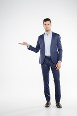 Full length portrait man holding invisible copyspace on the pound