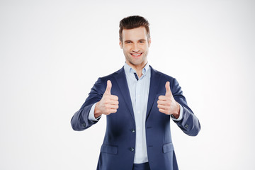 Smiling business man showing thumbs up