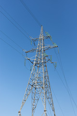 High-voltage electrical tower against the sky