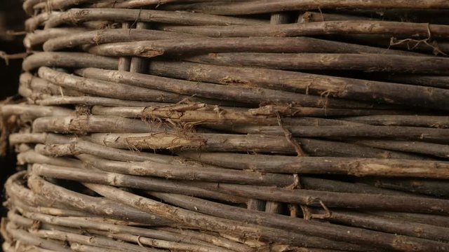 Slow tilt on old wicker basket handwork texture 4K 2160p 30fps UltraHD footage - Details of coiled container