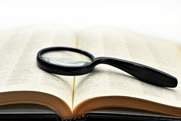 Old books with magnifying glass.