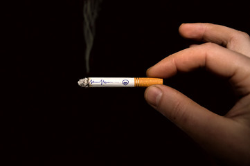 Burning cigarette with symbolic message