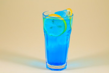 Colorful fruit cocktail on neutral background.