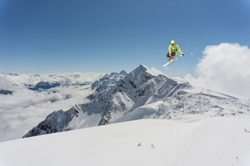 Flying skier on mountains. Extreme winter sport.