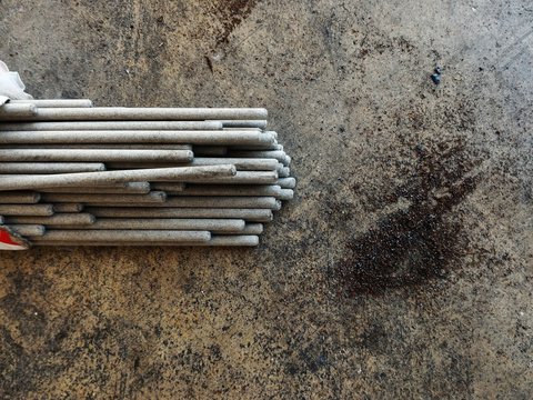 detail welding rod and metal dust on dirty ground