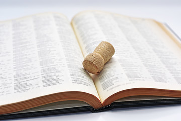 Old book with cork of wine