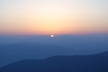 Fototapeta na wymiar Watching a beautiful sunrise from the top of the mountain
