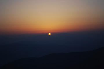 Watching a beautiful sunrise from the top of the mountain