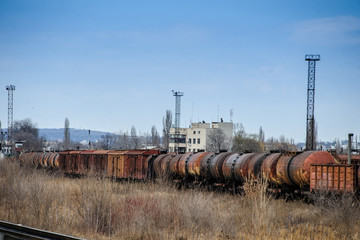 Fototapeta na wymiar Abandoned rusty railway containers for as and oil transportation