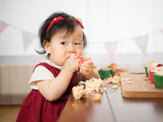 baby girl eating cup cake