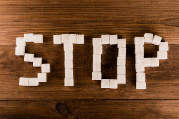 Diabetes. Word Stop from sugar cubes with syringe